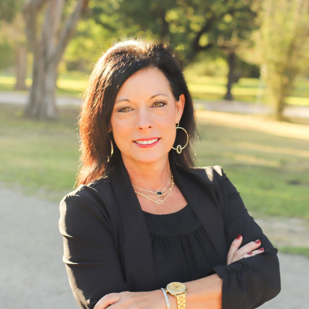 Woman in suit with arms crossed